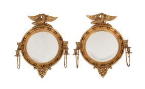 A PAIR OF GILTWOOD CONVEX WALL MIRRORS IN REGENCY STYLE