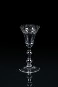 A ENGRAVED BALUSTER WINE GLASS