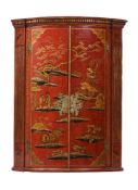 A RED LACQUER AND GILT CHINOISERIE DECORATED HANGING CORNER CABINETIN GEORGE III STYLE