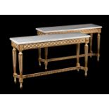 A PAIR OF PAINTED AND PARCEL GILT CONSOLE TABLES IN 19TH CENTURY TASTE