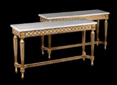 A PAIR OF PAINTED AND PARCEL GILT CONSOLE TABLES IN 19TH CENTURY TASTE