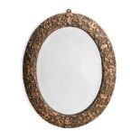 A CARVED GILT GESSO AND COMPOSITION OVAL MIRROR, IN LOUIS XIV STYLE