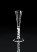 AN OPAQUE-TWIST RATAFIA GLASSTHIRD QUARTER 18TH CENTURYWith hammered flute lower section on a doub