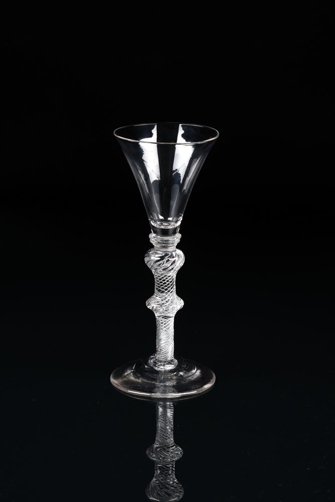 AN AIRTWIST WINE GLASSMID 18TH CENTURY On a double-knopped stem filled with spiral threads and a c