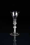 AN AIRTWIST WINE GLASSMID 18TH CENTURY On a double-knopped stem filled with spiral threads and a c