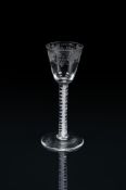 AN ENGRAVED OPAQUE TWIST WINE GLASSCIRCA 1765On a single series stem and conical foot
