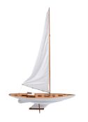 A MODERN PAINTED AND VARNISHED WOOD MODEL OF A POND YACHTThe mast and sail above the white hull and