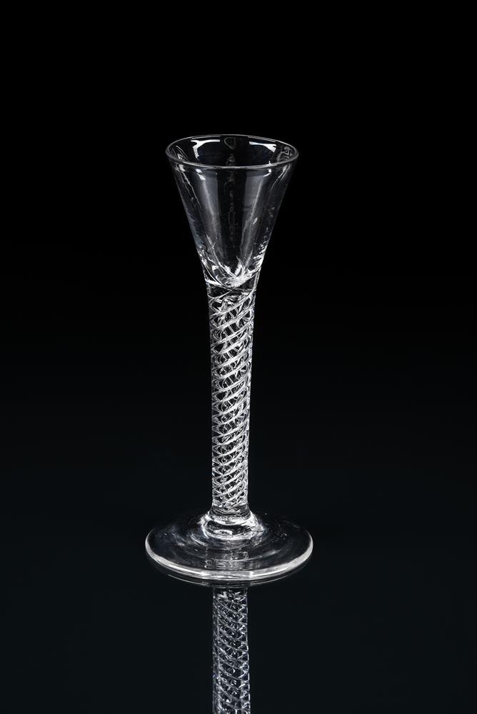 AN AIRTWIST CORDIAL GLASSMID 18TH CENTURYOf drawn trumpet form and with conical foot
