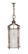 A PATINATED BRASS AND FROSTED GLASS HANGING LANTERN