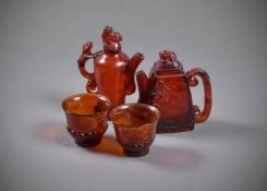 Two Chinese carved amber wine ewers and two cups