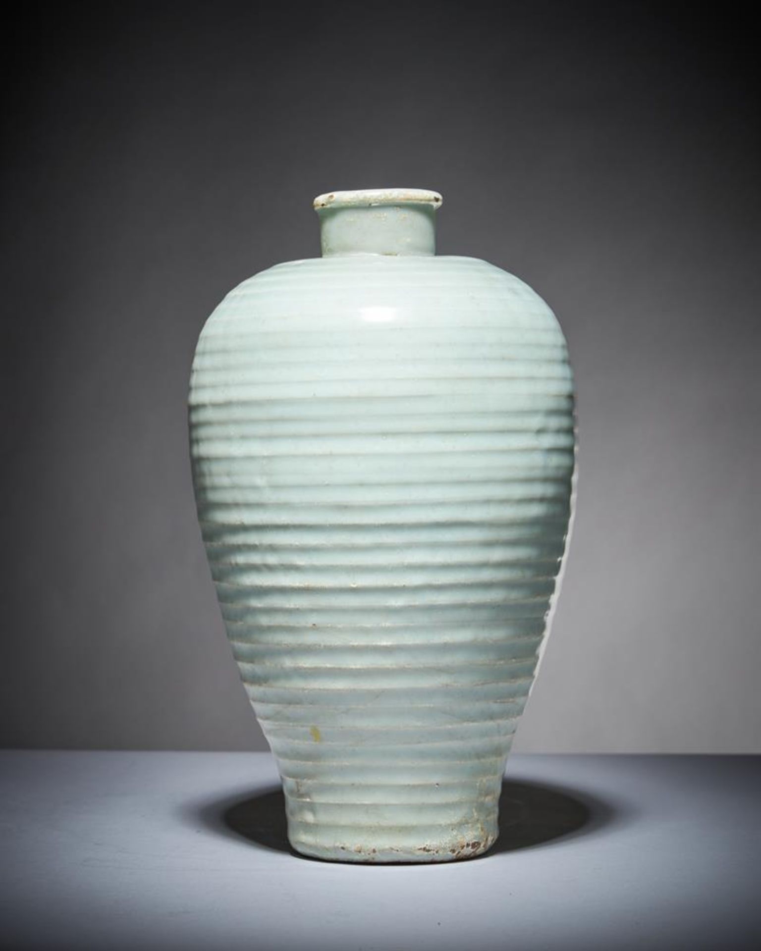 A Chinese pale celadon ribbed vase