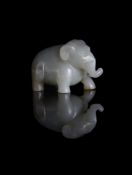 A Chinese pale celadon and russet jade Elephant