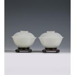 A pair of Chinese pale celadon or white jade bowls and covers