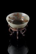 A Chinese celadon jade gilt-decorated bowl