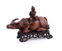 A Chinese carved boxwood group of buffalo and boy