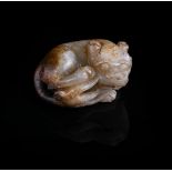 A Chinese white and russet jade lion