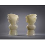 A pair of pale celadon jade archaistic vases