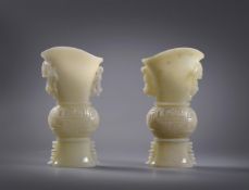 A pair of pale celadon jade archaistic vases