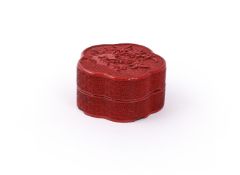 A small Chinese carved cinnabar lacquer lobed box and cover