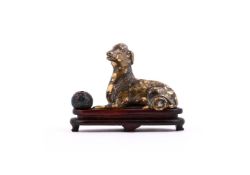 A Chinese bronze and splashed gold paper weight of a qilin