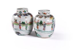 A pair of Chinese famille verte jars and covers