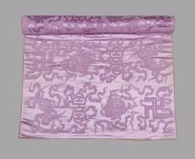 A Chinese lilac bolt of silk damask woven with bold symbols of long life