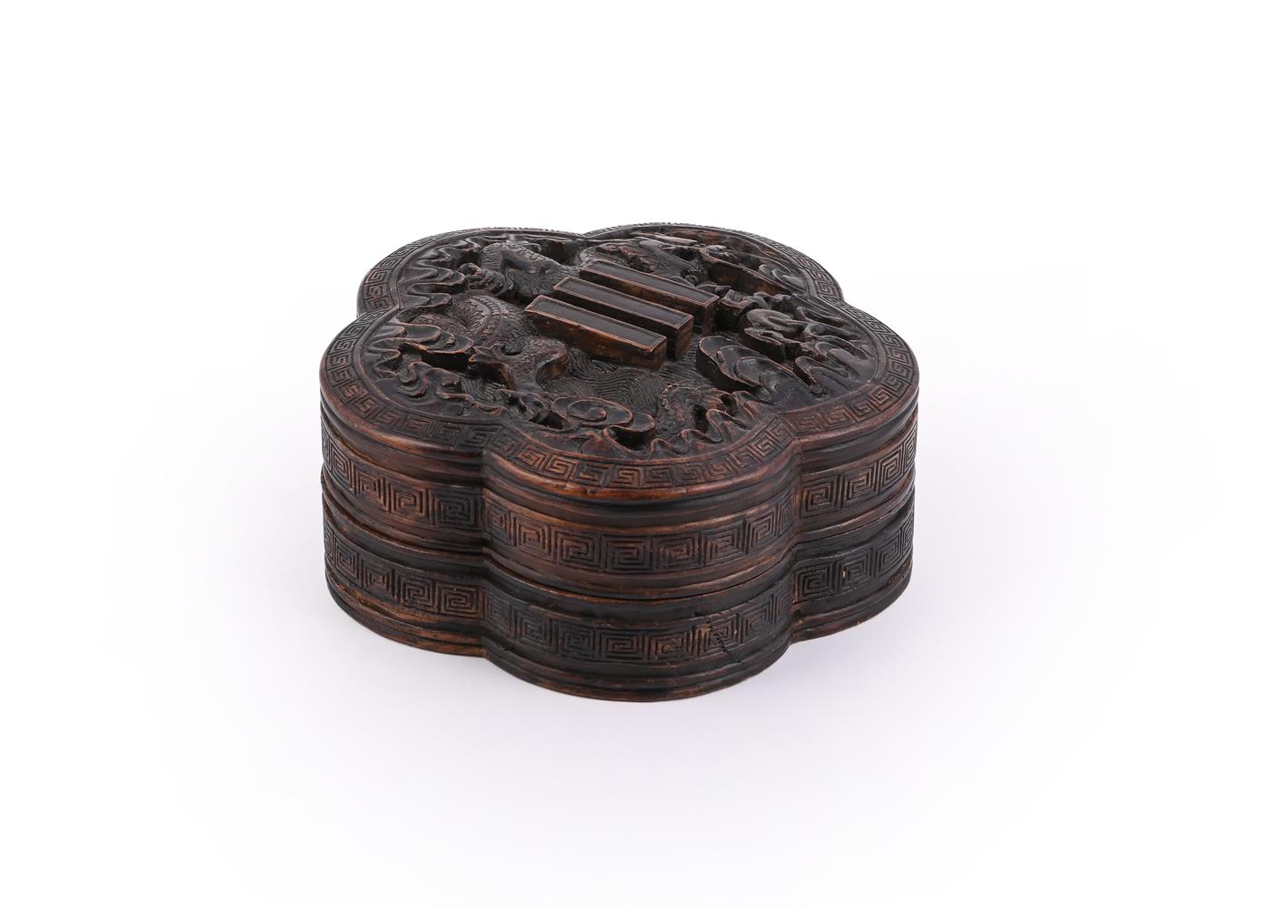 A Chinese lobed hardwood 'Dragon and Trigram' box and cover