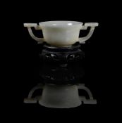 A Chinese celadon jade twin handled cup