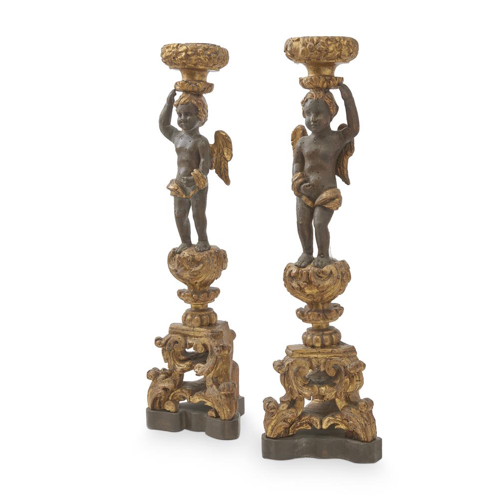 A PAIR OF CARVED AND PARCEL GILT DECORATED BAROQUE FIGURAL CANDLESTANDS ITALIAN, 17TH CENTURY