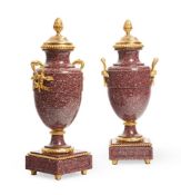 A PAIR OF ORMOLU MOUNTED RED PORPHYRY URNS FRENCH, LATE 19TH CENTURY