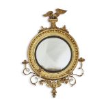 A REGENCY GILTWOOD AND COMPOSITION CONVEX WALL MIRROR, CIRCA 1815