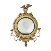 A REGENCY GILTWOOD AND COMPOSITION CONVEX WALL MIRROR, CIRCA 1815