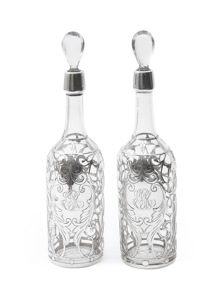A PAIR OF AMERICAN GLASS AND SILVER COLOURED OVERLAY BOTTLES STAMPED STERLING, CIRCA 1920