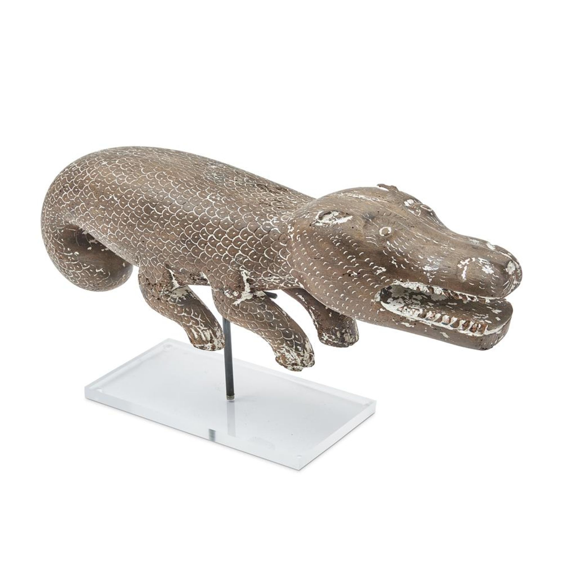 CARVED WOODEN SCULPTURE OF A CROCODILE WITH TRACES OF PLASTER INDIAN, CIRCA 1900, ON A LATER STAND