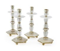 A SET OF FOUR BAROQUE STYLE ROCK CRYSTAL CANDLESTICKS BY GUINEVERE