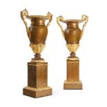 A LARGE PAIR OF CHARLES X GILT AND PATINATED BRONZE TWIN HANDLED URNS FRENCH, MID 19TH CENTURY