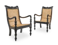 A PAIR OF EBONISED HARDWOOD ARMCHAIRS IN ANGLO-INDIAN, MID 19TH CENTURY TASTE