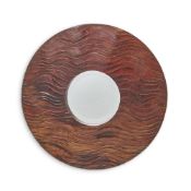 A CIRCULAR MOLAVE WOOD MIRROR IN A CARVED WAVE PATTERN, 19TH CENTURY AND LATER