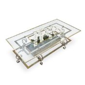 A BRASS, STEEL AND GLASS LOW CENTRE TABLE CIRCA 1965, POSSIBLY SPANISH