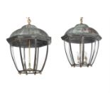 A PAIR OF VERDIGRIS AND GILTMETAL MOUNTED HANGING LANTERNS IN REGENCY STYLE