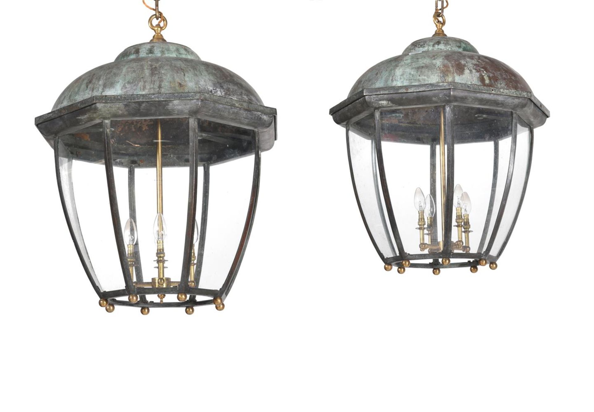 A PAIR OF VERDIGRIS AND GILTMETAL MOUNTED HANGING LANTERNS IN REGENCY STYLE