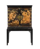 A BLACK LACQUER AND GILT CHINOISERIE DECORATED CABINET ON STAND