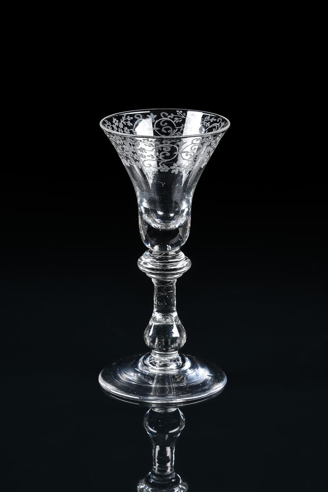 AN ENGRAVED BALUSTER WINE GLASS
