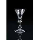 AN ENGRAVED BALUSTER WINE GLASS