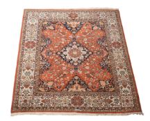 A HEAVY IRON RED GROUND WOOL RUG