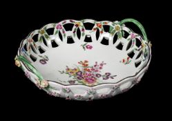 A WORCESTER POLYCHROME PIERCED TWO-HANDLED BASKET