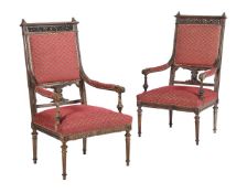 A PAIR OF NORTH ITALIAN CARVED WALNUT AND UPHOLSTERED ARMCHAIRS