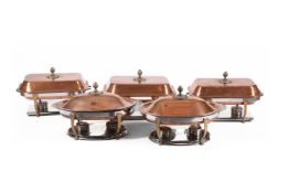 A SUITE OF FIVE COPPER COLOURED AND CHROMED METAL SERVING DISHES AND COVERS