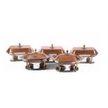 A SUITE OF FIVE COPPER COLOURED AND CHROMED METAL SERVING DISHES AND COVERS