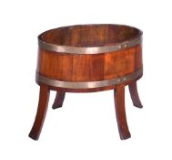 A MAHOGANY AND COPPER BOUND JARDINERE STAND